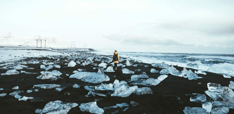 man walking on the Diamond Beach in south Iceland