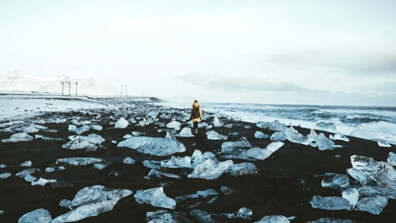 man walking on the Diamond Beach in south Iceland