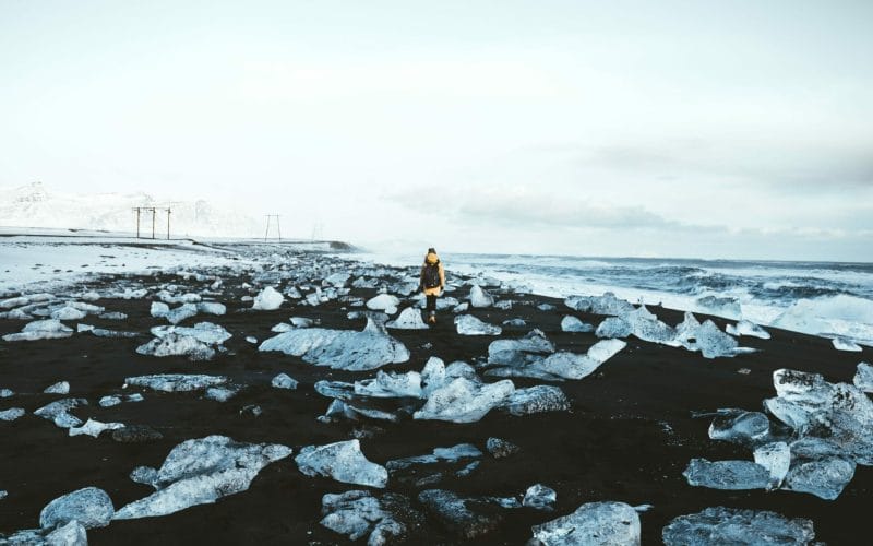 man walking on the Diamond Beach in south Iceland