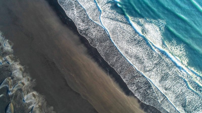 Drone flying in Iceland, Black sand beach in Iceland seen from a drone