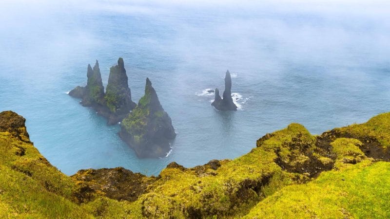 Reynisdrangar cliffs in Reynisfjara black sand beach, Trolls in Iceland