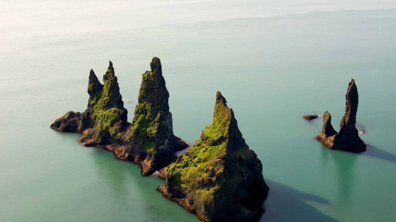 Reynisdrangar cliffs in Reynisfjara black sand beach, Trolls in Iceland