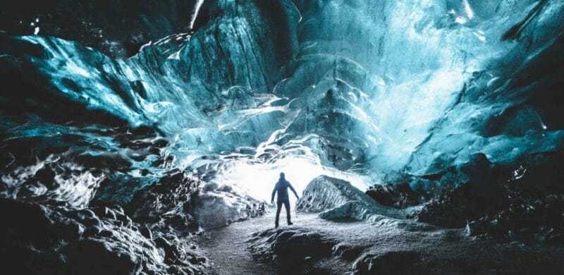 Ice Cave Tours, a man standing inside Katla Ice Cavel the best summer self driving tours in Iceland