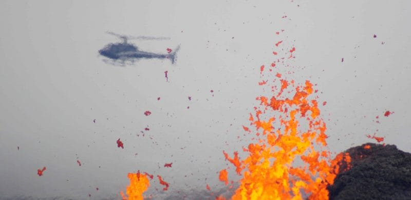 active volcano tour, helicopter flying over Geldingadalur erupting volcano in Iceland