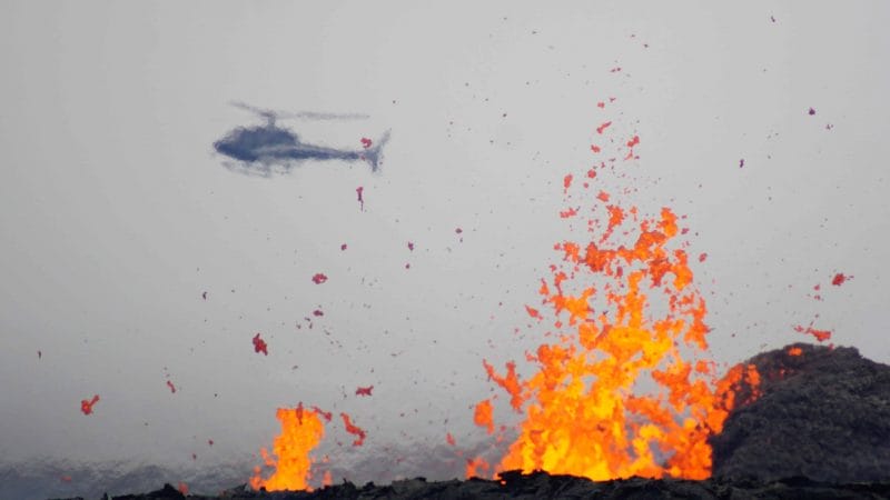 active volcano tour, helicopter flying over Geldingadalur erupting volcano in Iceland