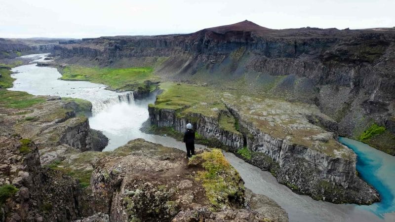 man standing on the viewpoint at Hafragilsfoss waterfall in the diamond circle in north Iceland