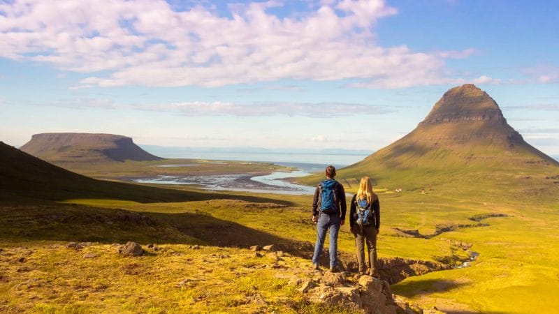 Honeymoon in Iceland, people hiking next to Kirkjufell mountain