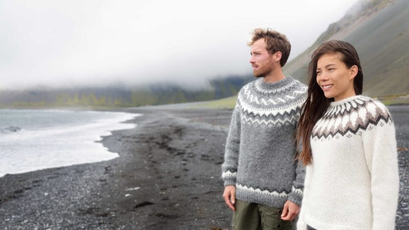 couple at the black sand beach, Honeymoon in Iceland