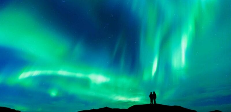 Northern Lights Iceland | Iceland Travel Guide, Honeymoon in Iceland, two people watching the northern lights in Iceland