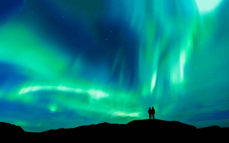 Northern Lights Iceland | Iceland Travel Guide, Honeymoon in Iceland, two people watching the northern lights in Iceland