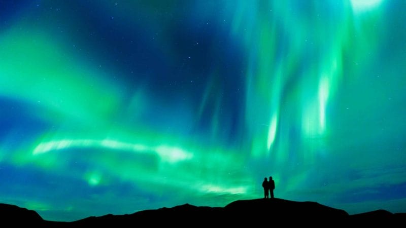 Northern Lights Iceland | Iceland Travel Guide, Honeymoon in Iceland, two people watching the northern lights in Iceland