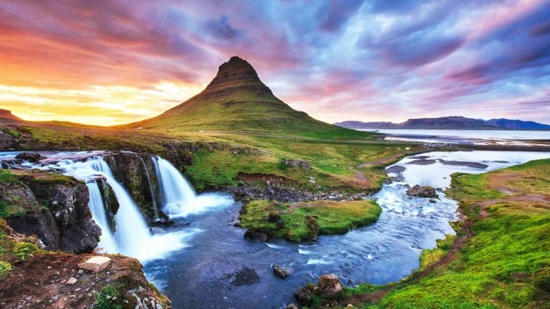 Kirkjufell mountain and Kirkjufellsfoss waterfall at sunset in Snæfellsnes Peninsula