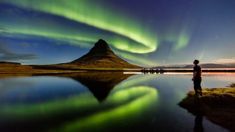 northern lights aurora borealis dancing over Kirkjufell mountain and Kirkjufellsfoss waterfall in Snæfellsnes Peninsula