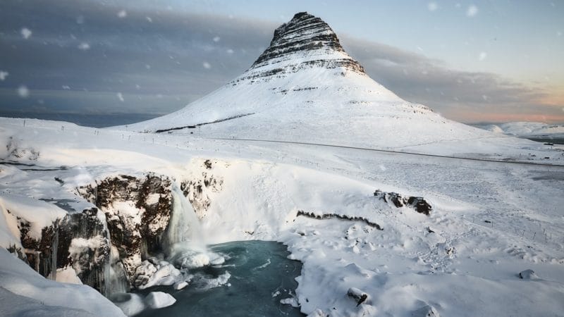 Kirkjufell mountain and Kirkjufell waterfall in Snæfellsnes during winter with snow