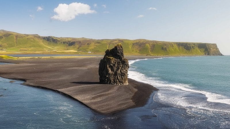 Kirkjufjara black sand beach and Eagle Rock in south Iceland