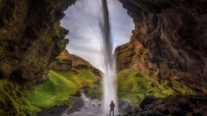 Kvernufoss waterfall during summer in Iceland, walk behind waterfall in south Iceland, hidden waterfall in south Iceland