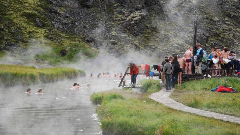 people bathing in Landmannalaugar hot springs