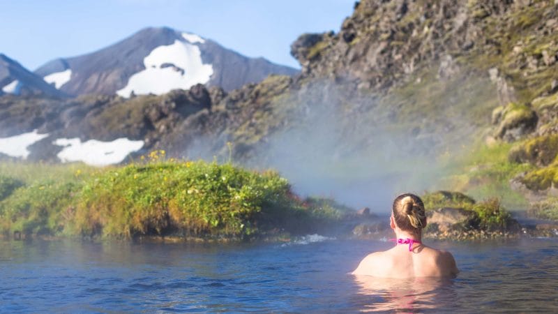 Iceland hot spring, woman bathing in Landmannalaugar hot spring in the highlands of Iceland