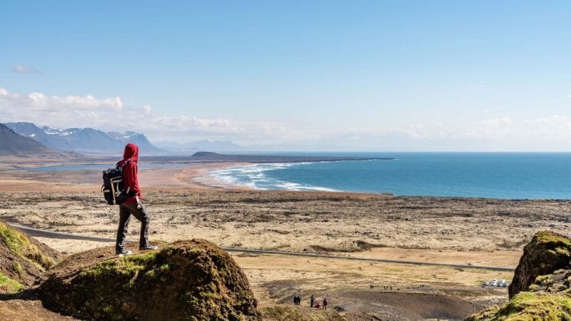 man standing with a view over Snæfellsnes Peninsula from Rauðfeldsgjá Gorge in Snæfellsnes Peninsula