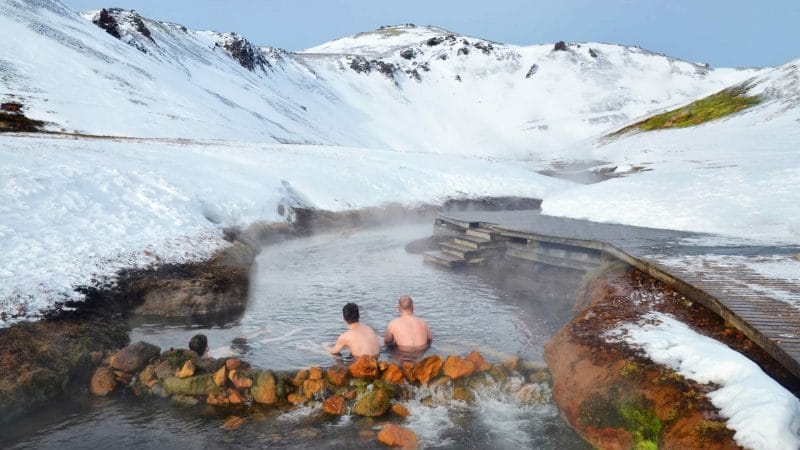 Iceland Hot Springs, hot springs in Iceland, two men sitting in Reykjadalur hot spring on the Reykjadalur hot spring and hike