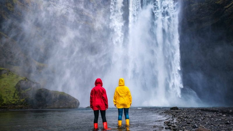 People Standing in Front of Skógafoss Waterfall - South Iceland Tours