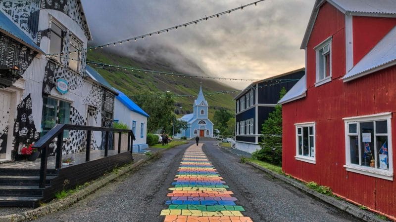 Seyðisfjörður, rainbow street and blue church in Seyðisfjordur village in east Iceland