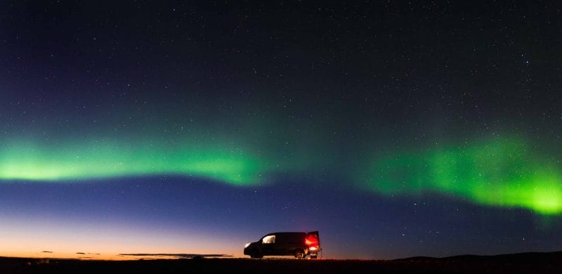 Happy Campers camper van under the northern lights in Iceland