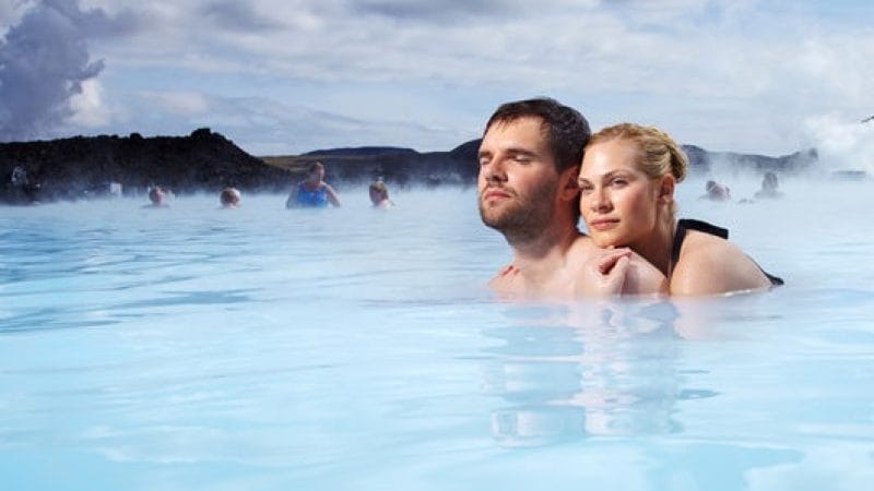 A couple bathing in the Blue Lagoon in Iceland