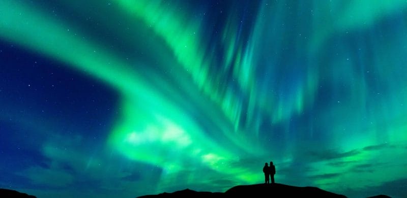 Aurora Tours, Northern Lights Tours in Iceland, Northern Lights Iceland | Iceland Travel Guide, two people watching the Northern Lights in Iceland