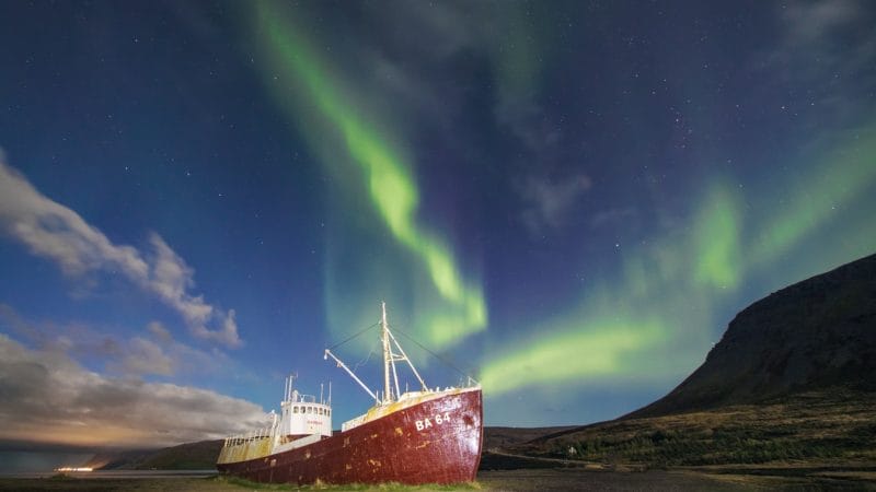 northern lights over Garðar BA 64 Ship wreck in Westfjords